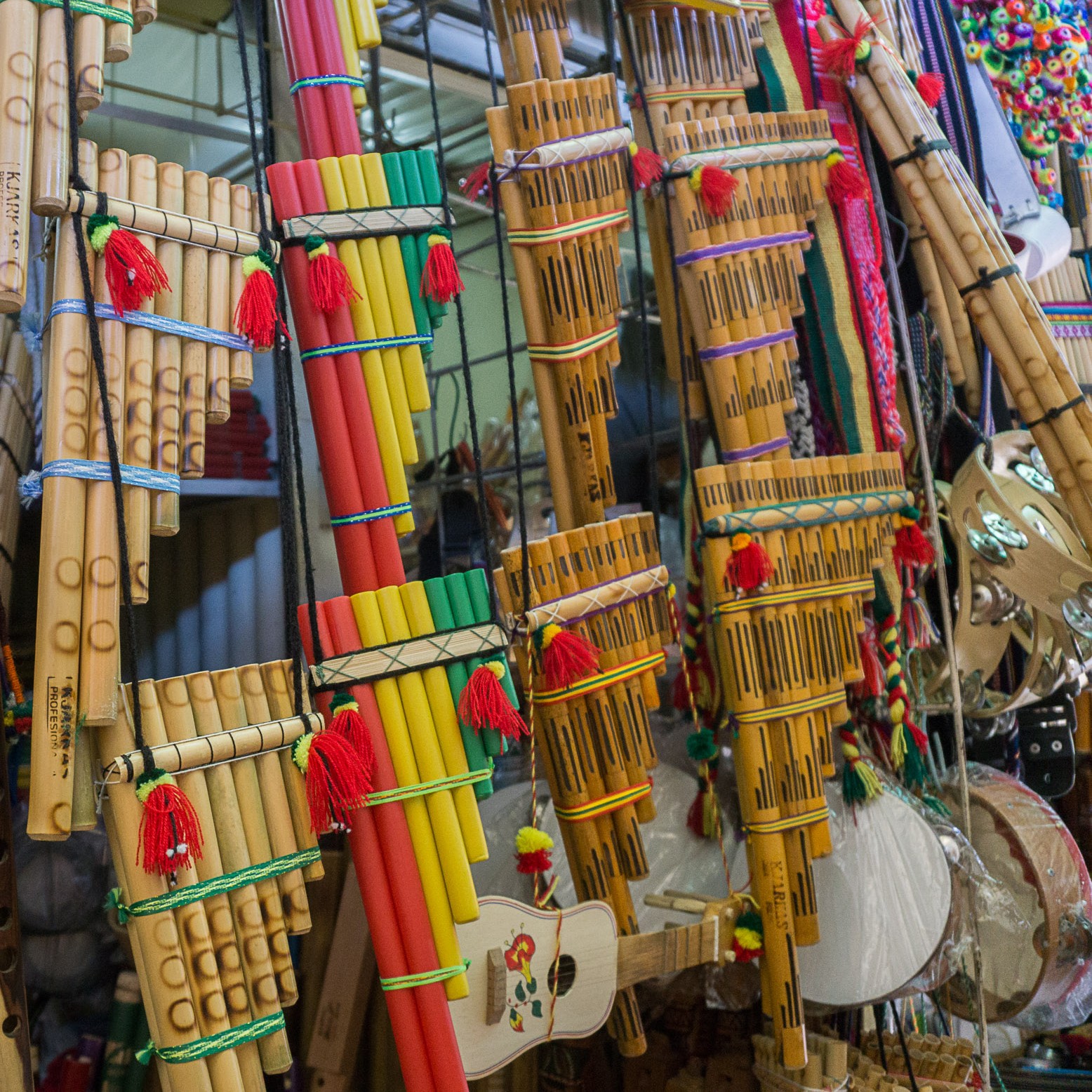 Panflöten aus Bolivien, teilweise in den Landesfarben rot, gelb, grün, an einem Marktstand