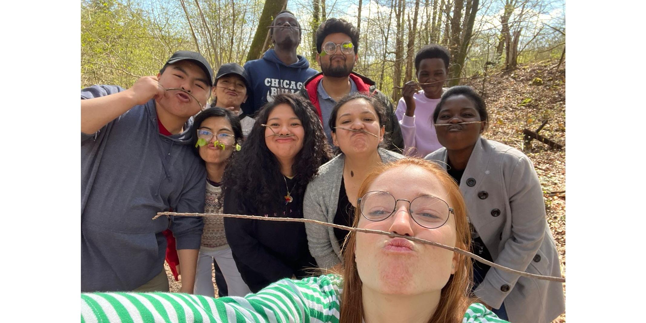 Junge Menschen posieren fröhlich für ein Selfie und balancieren dabei einen Zweig zwischen Oberlippe und Nase. (c) SoFiA e. V. Junge Menschen posieren fröhlich für ein Selfie und balancieren dabei einen Zweig zwischen Oberlippe und Nase.