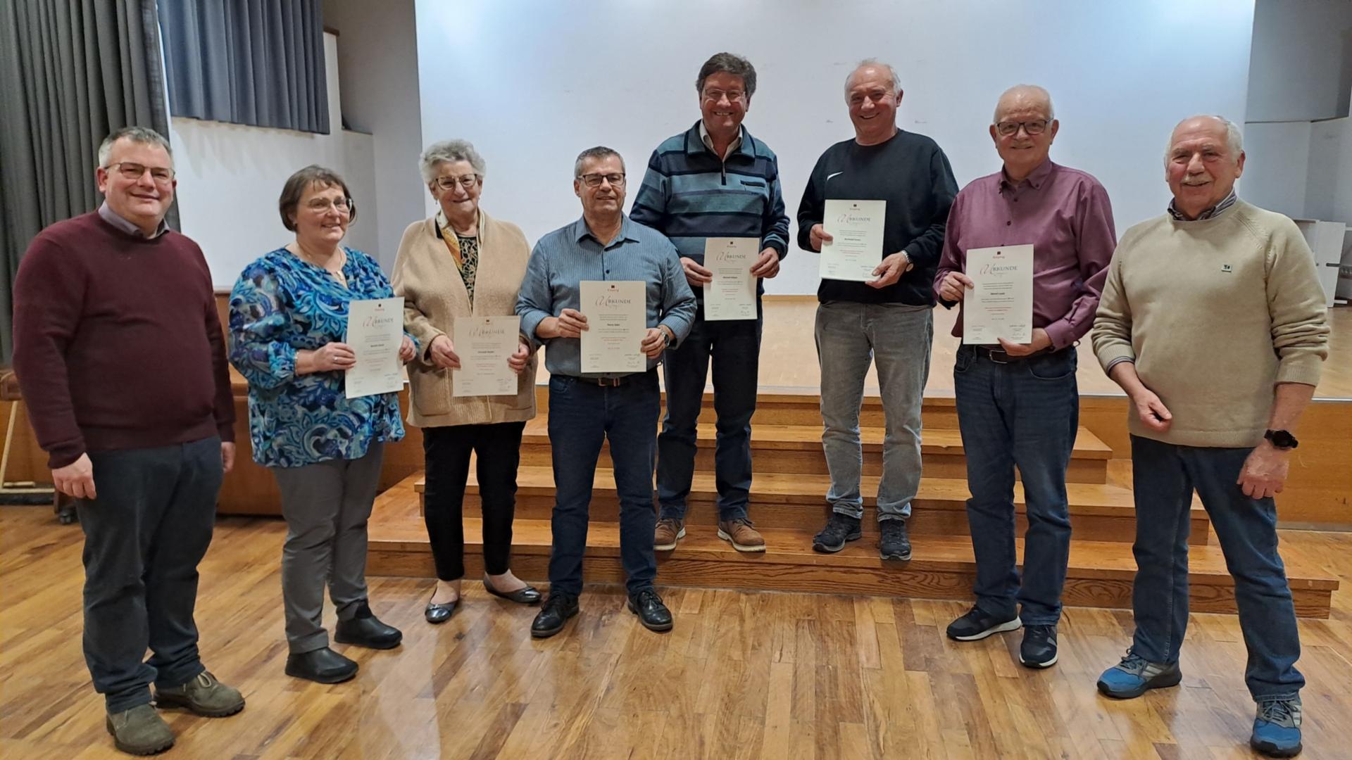 Mitglieder der Kolpingsfamilie zeigen ihre Urkunden mit der Ehrung