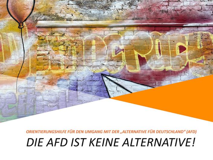 Bild einer bunt besprühten Ziegelmauer mit dem Schriftzug Democracy