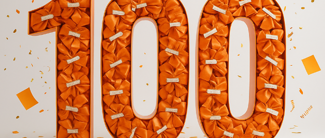 Die Zahl einhundert in Orange mit Konfetti
