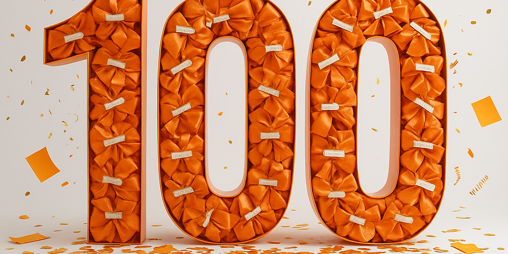 Die Zahl einhundert in Orange mit Konfetti