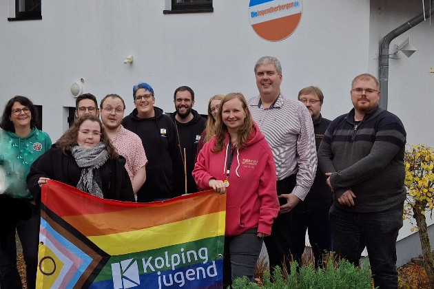 Gruppenbild vor der Jugendherberge Tholey mit Pride Banner der Kolpingjugend